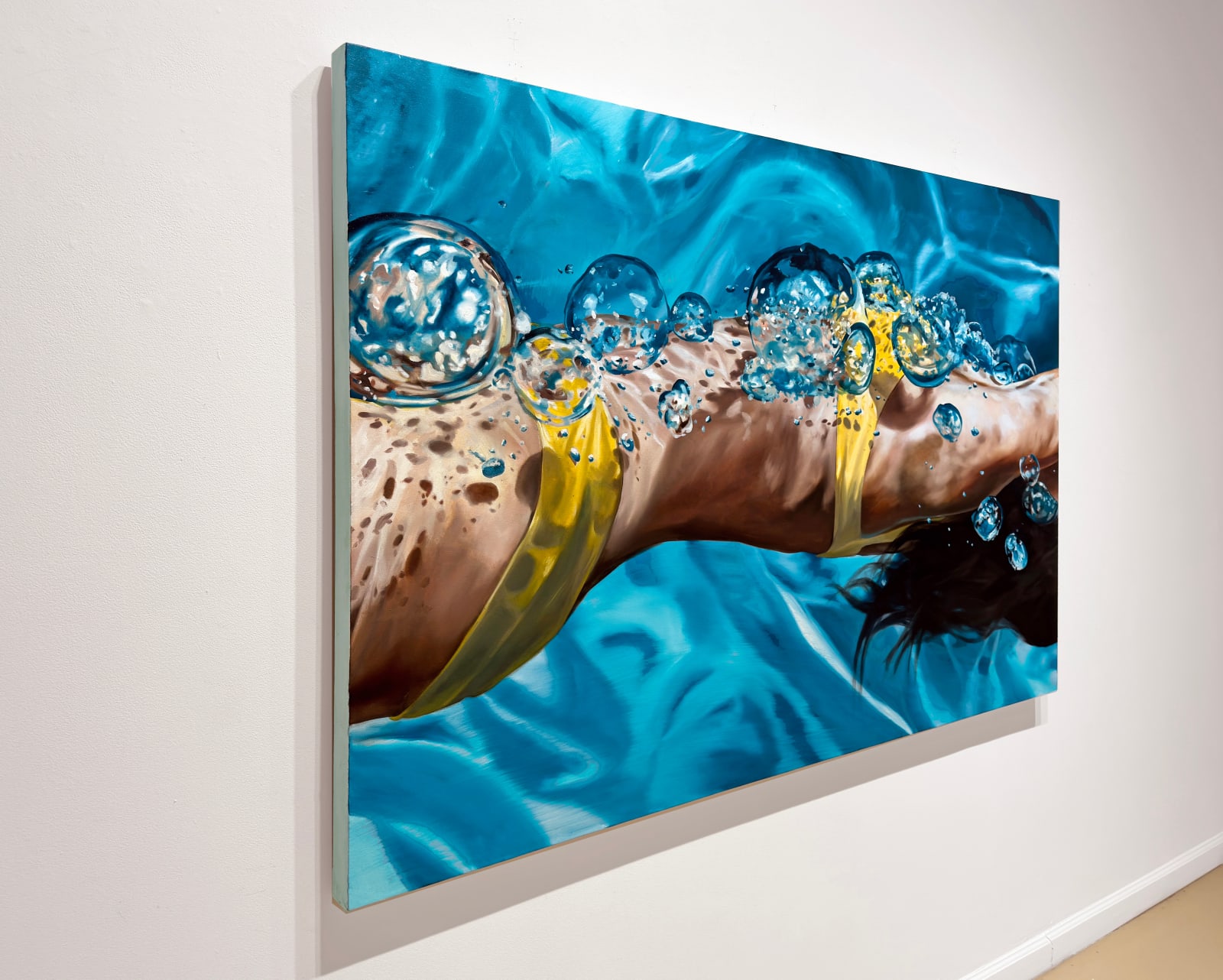 Torso of female swimmer in yellow bathing suit