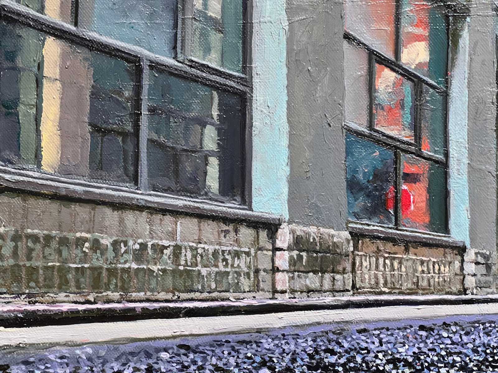 Panoramic view of Street, with a puddle in the foreground reflecting the buildings and the blue sky above.