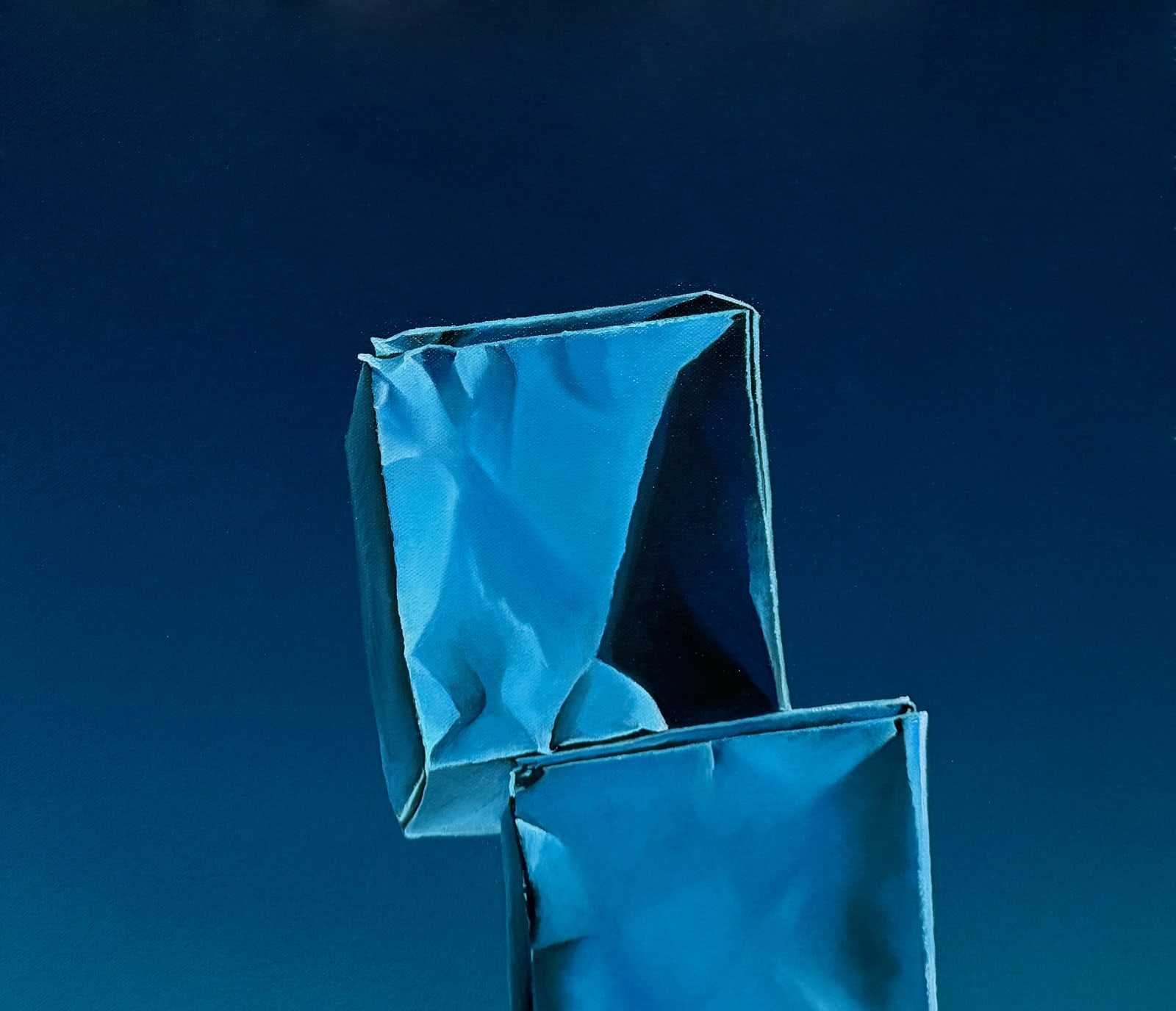 Stack of origami paper boxes on a blue background