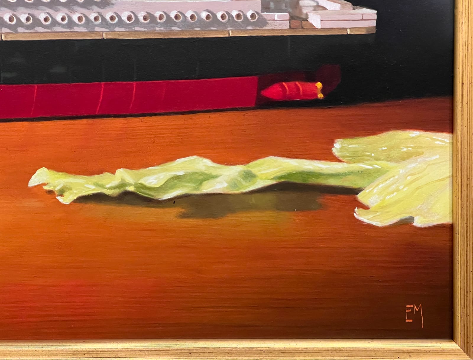 Detail of A toy replica of the HMS Titanic is placed amongst the cut up pieces of a head of iceberg lettuce.