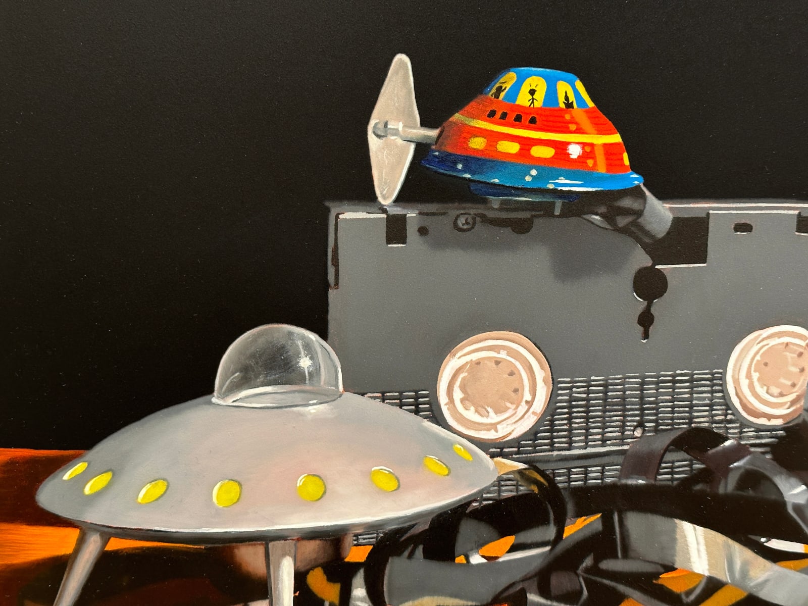 Painting of toy spaceships and VHS tape
