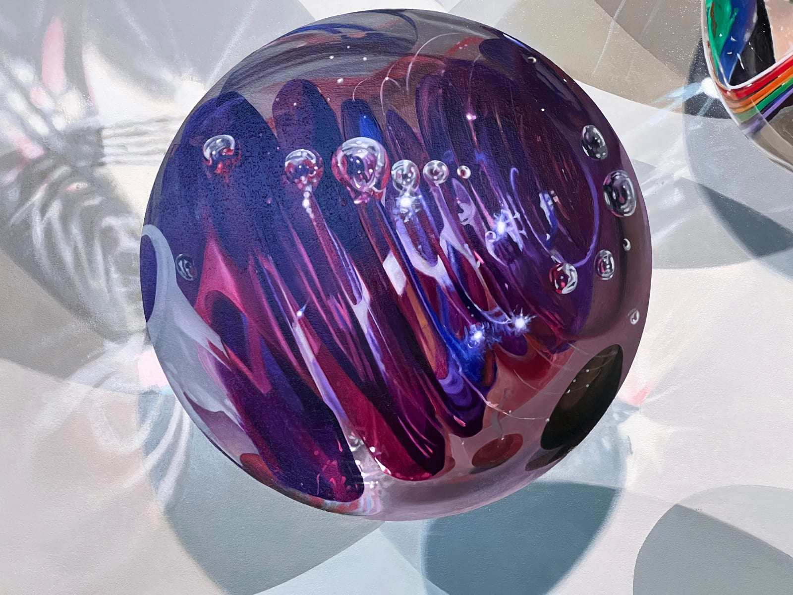 Photorealist painting of colorful marbles