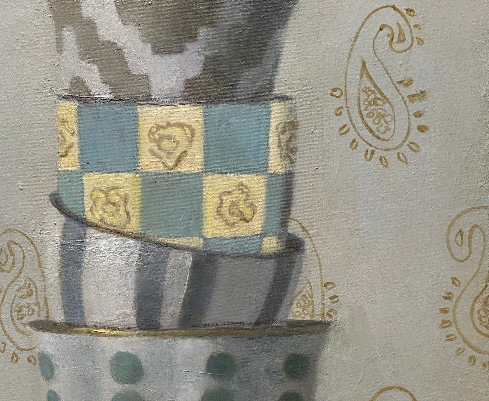 Stacked porcelain cups on a table with gold filigree background