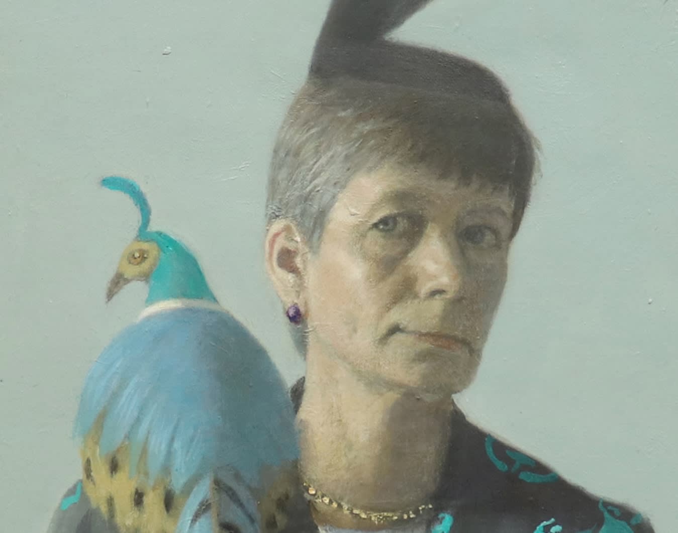 Detail of woman's face and pheasant