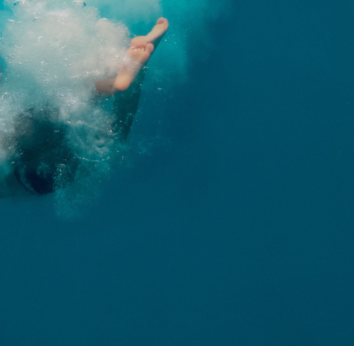 Mixed media resin work of man tumbling in bubble plume