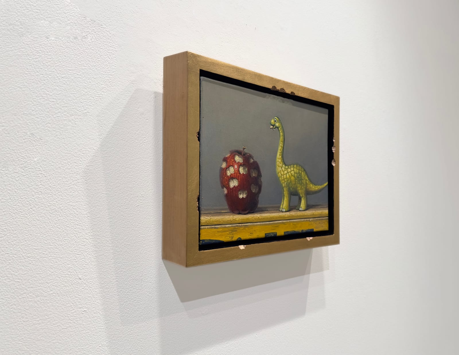 Painting of a dinosaur with a bit apple beside it, all surrounded by a bitten frame