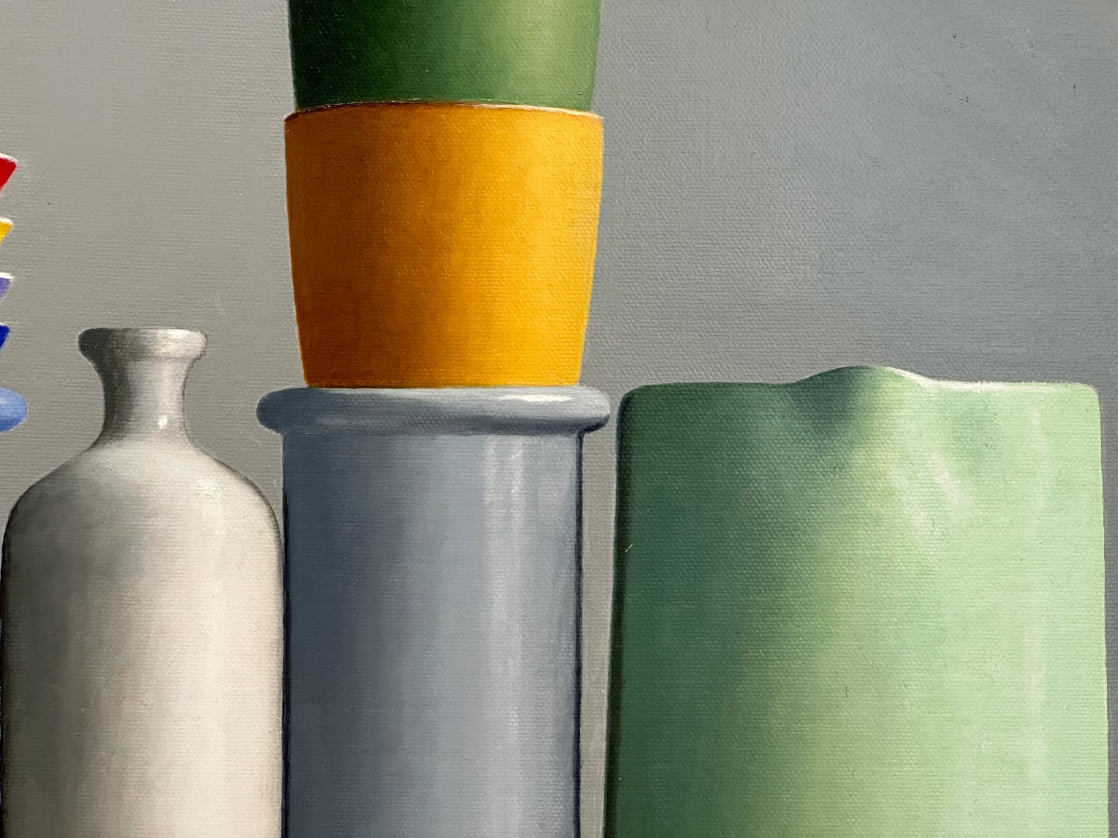 Blue and Yellow vessels on a table with a bird cup