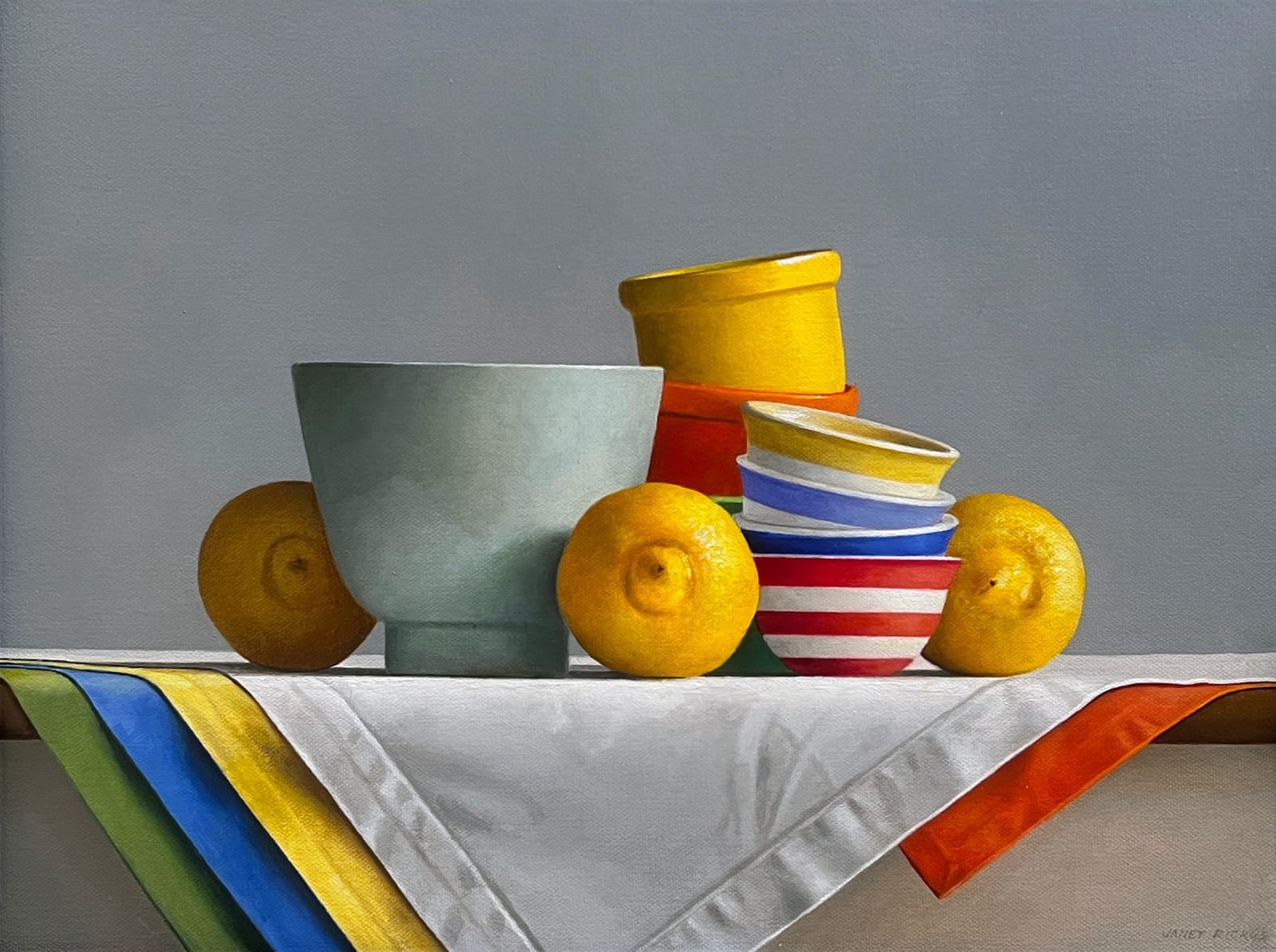 Lemons around light green bowl, stack of striped bowls, and small bowls