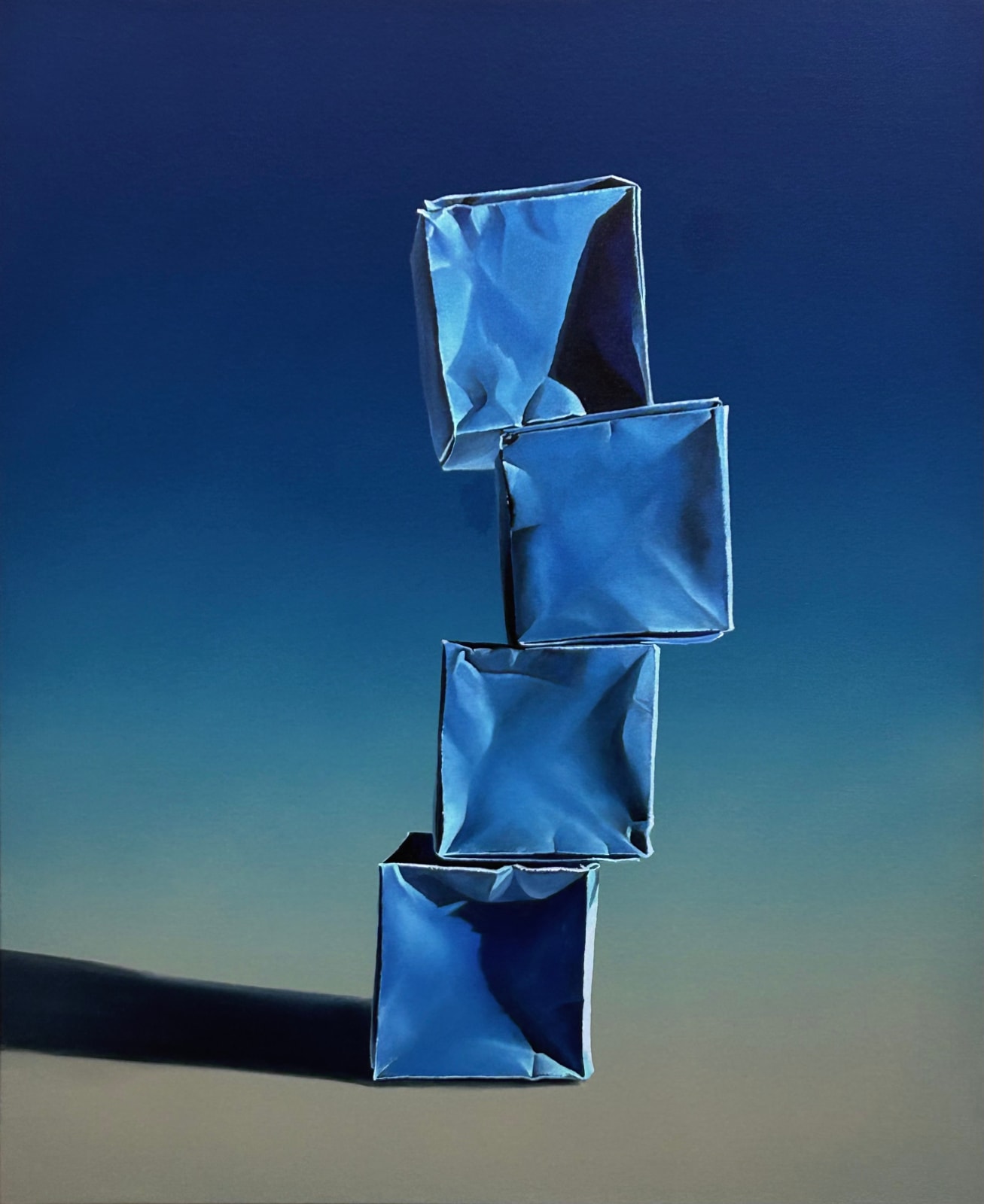 Stack of origami paper boxes on a blue background