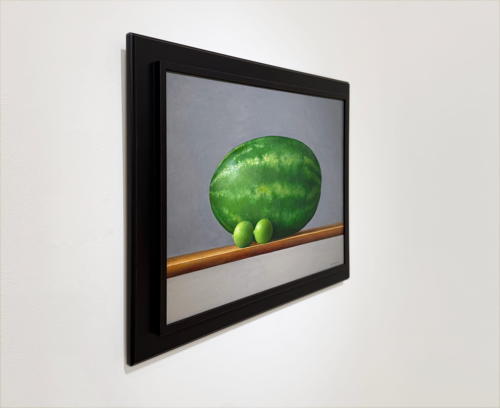 Still life painting of a watermelon with two limes
