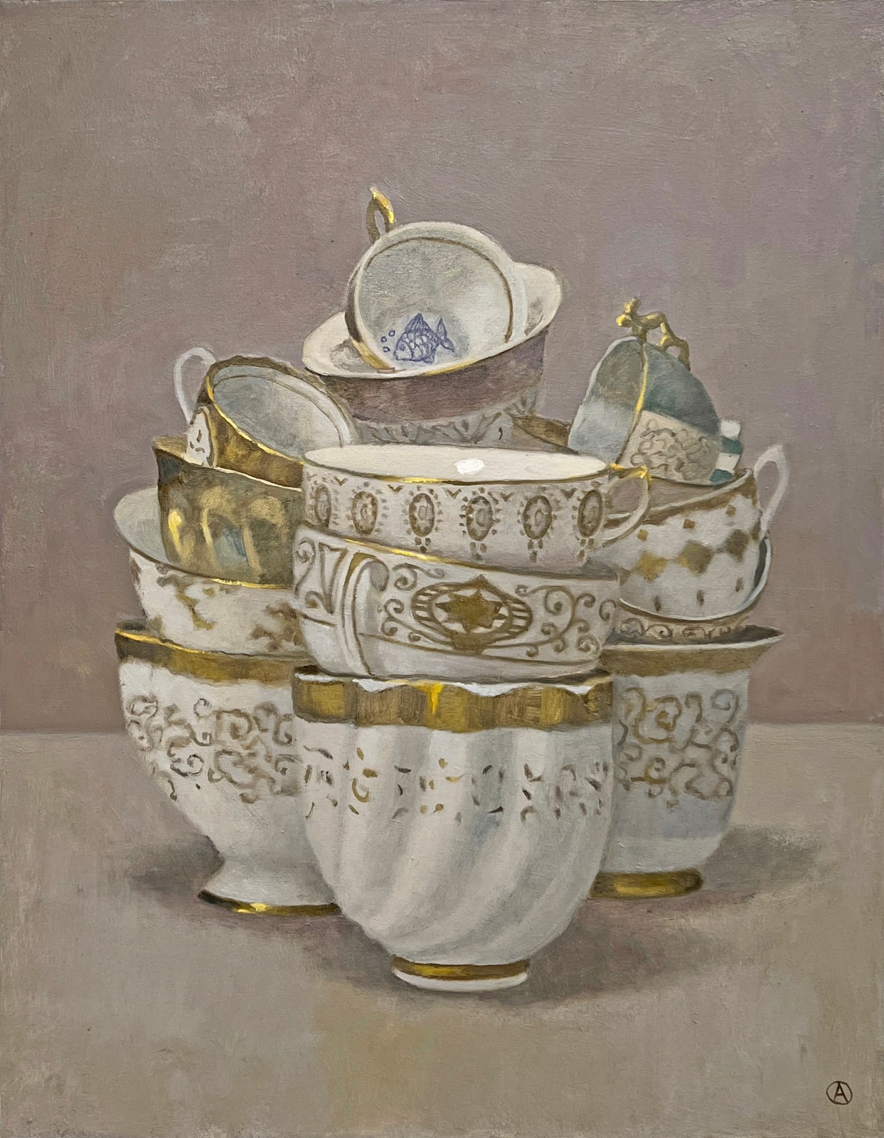 3 stacks of gold and white tea cups with blue fish in tea cup