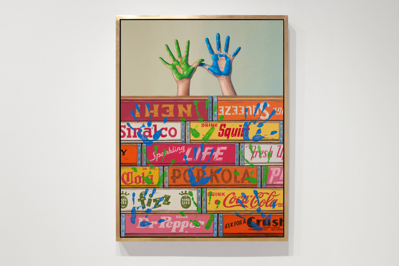 Painted hands above boxes in blue and green with prints all over boxes