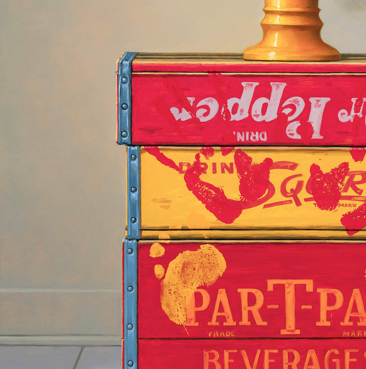 Left side detail of Flowers made from Coca Cola cans on top of red and yellow soda boxes with hand and foot prints