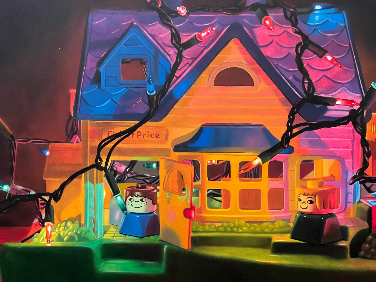 Detail of A Fischer Price Play house is wrapped and filled with a strand of colored lights with different Fischer Price toy characters placed in and around the house