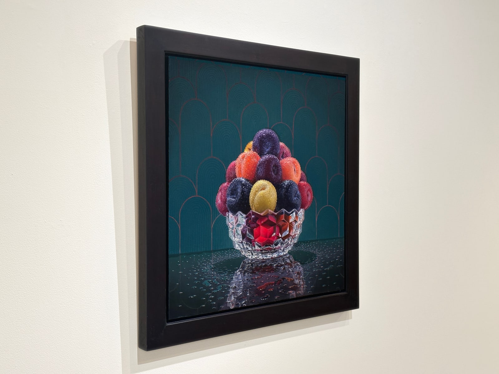 Bowl of plums with water droplets
