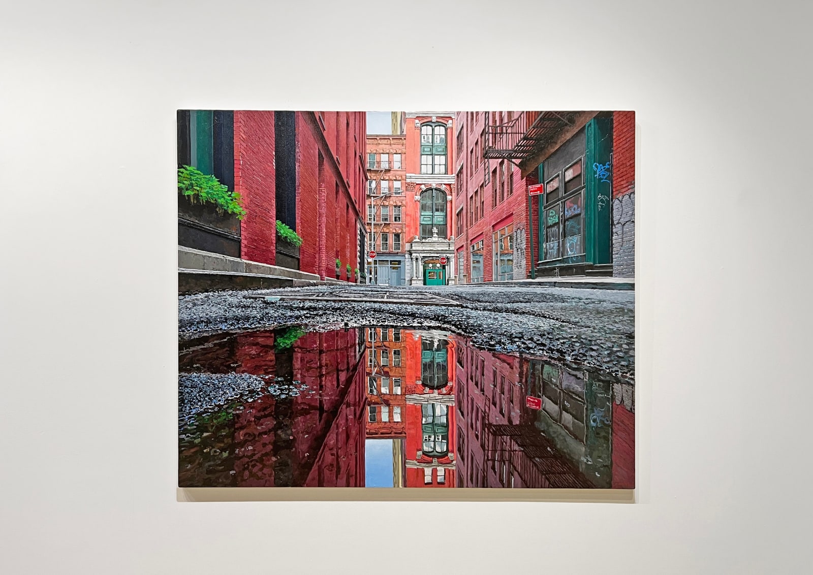 low viewpoint of a puddle on a narrow Tribeca Street
