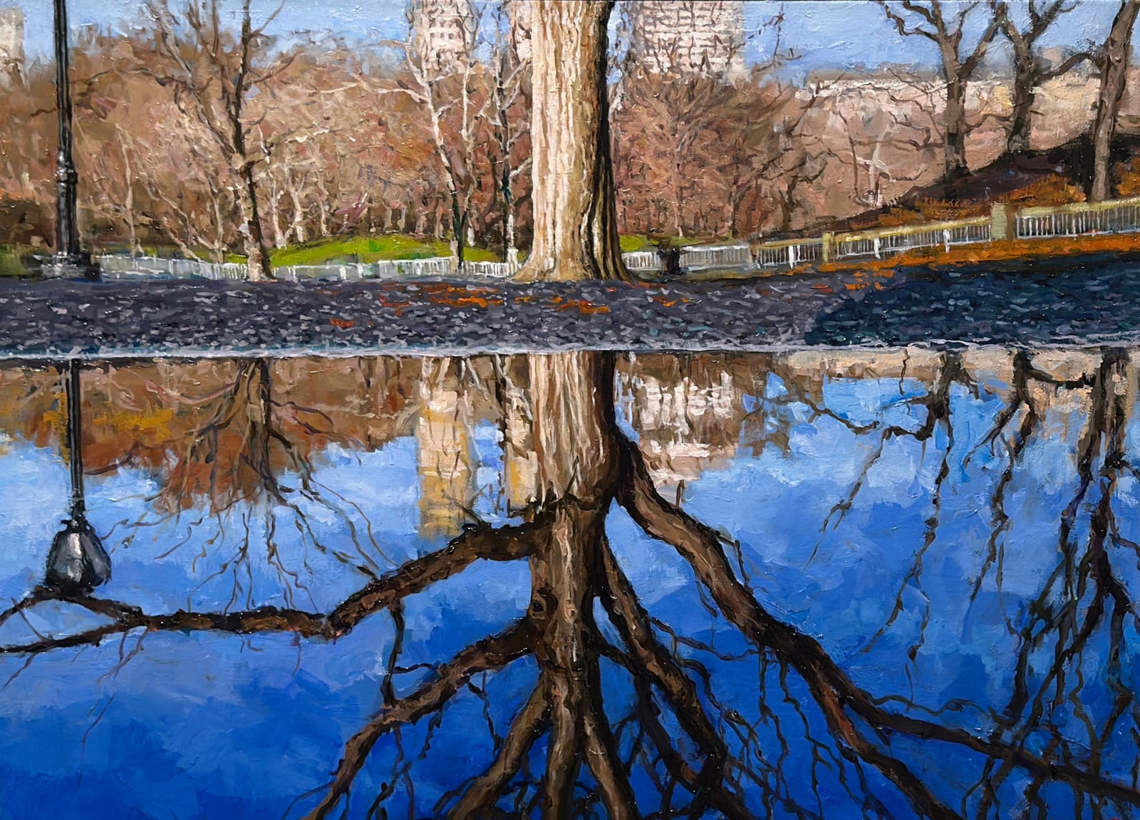 Landscape of a tree in a park reflecting in water