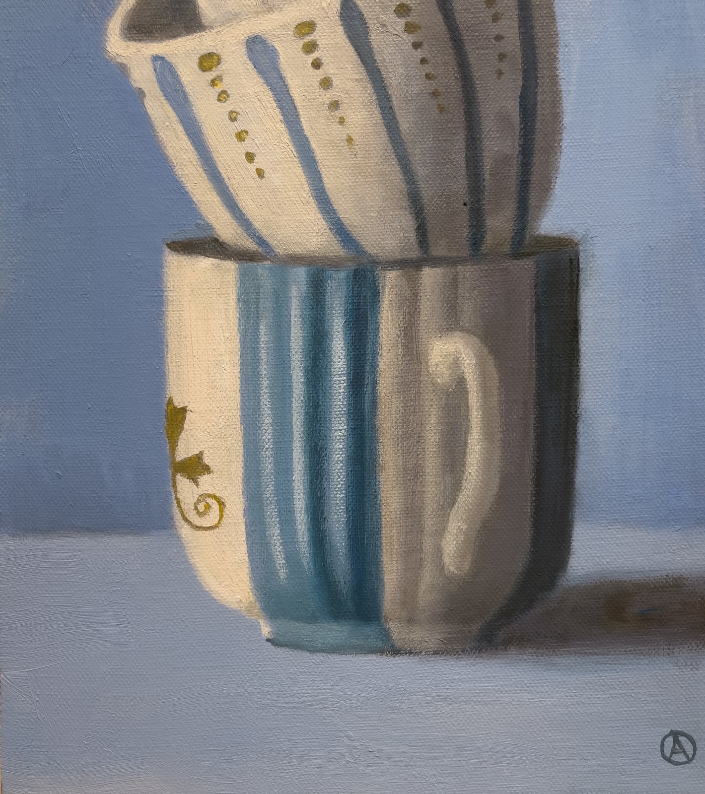 painted stack of tea cups on blue background