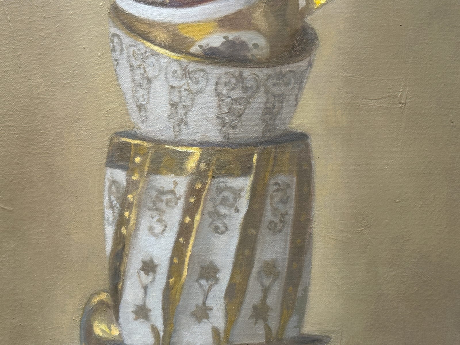 Stack of gold teacups in tower formation