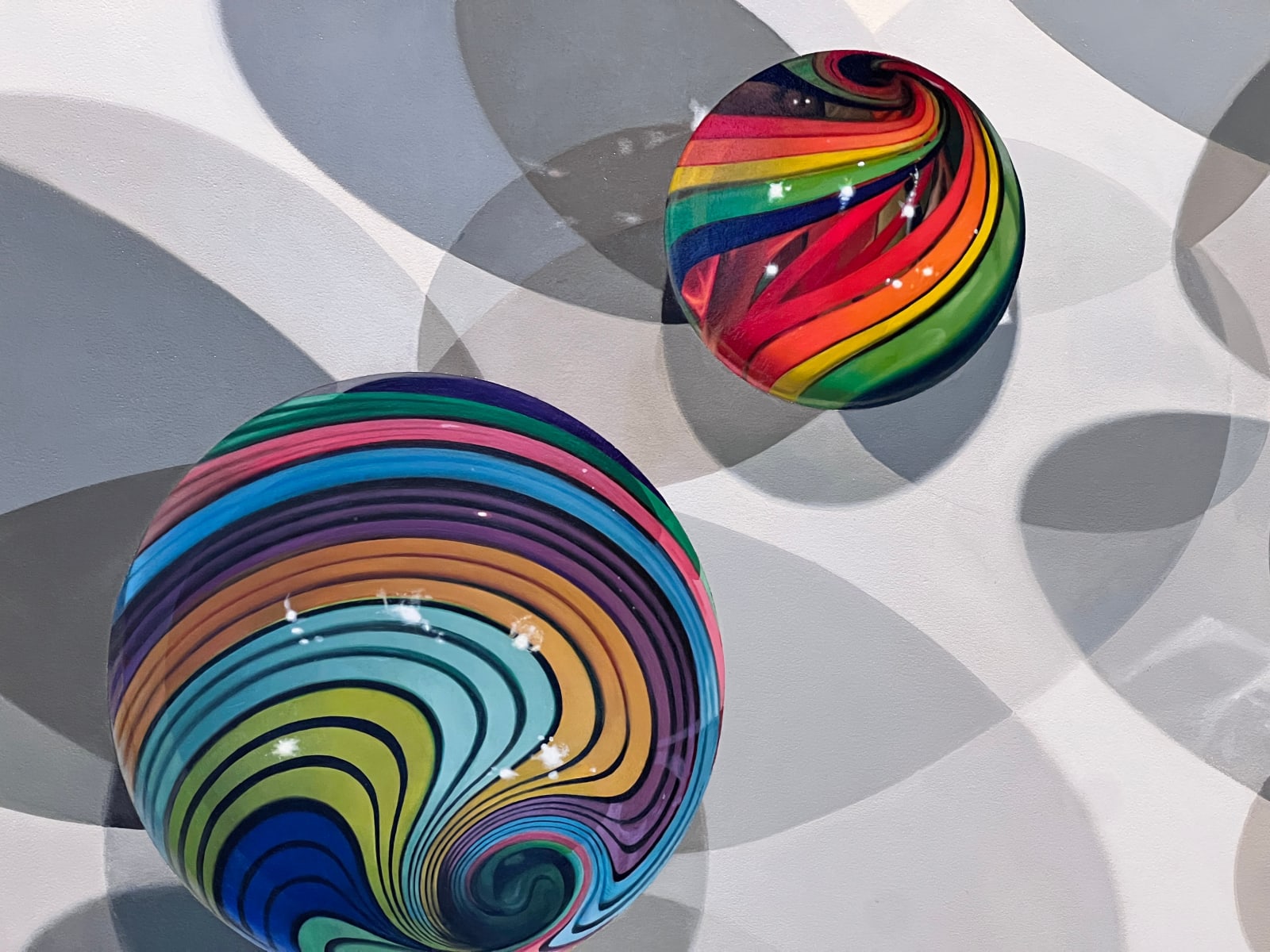 Photorealist painting of colorful marbles