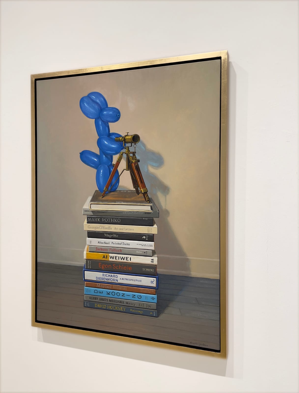 Painting of blue balloon dog on top of a stack of art books