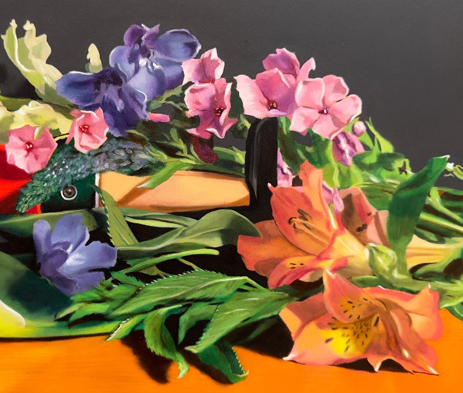 Still life painting of a Pinocchio doll under flowers