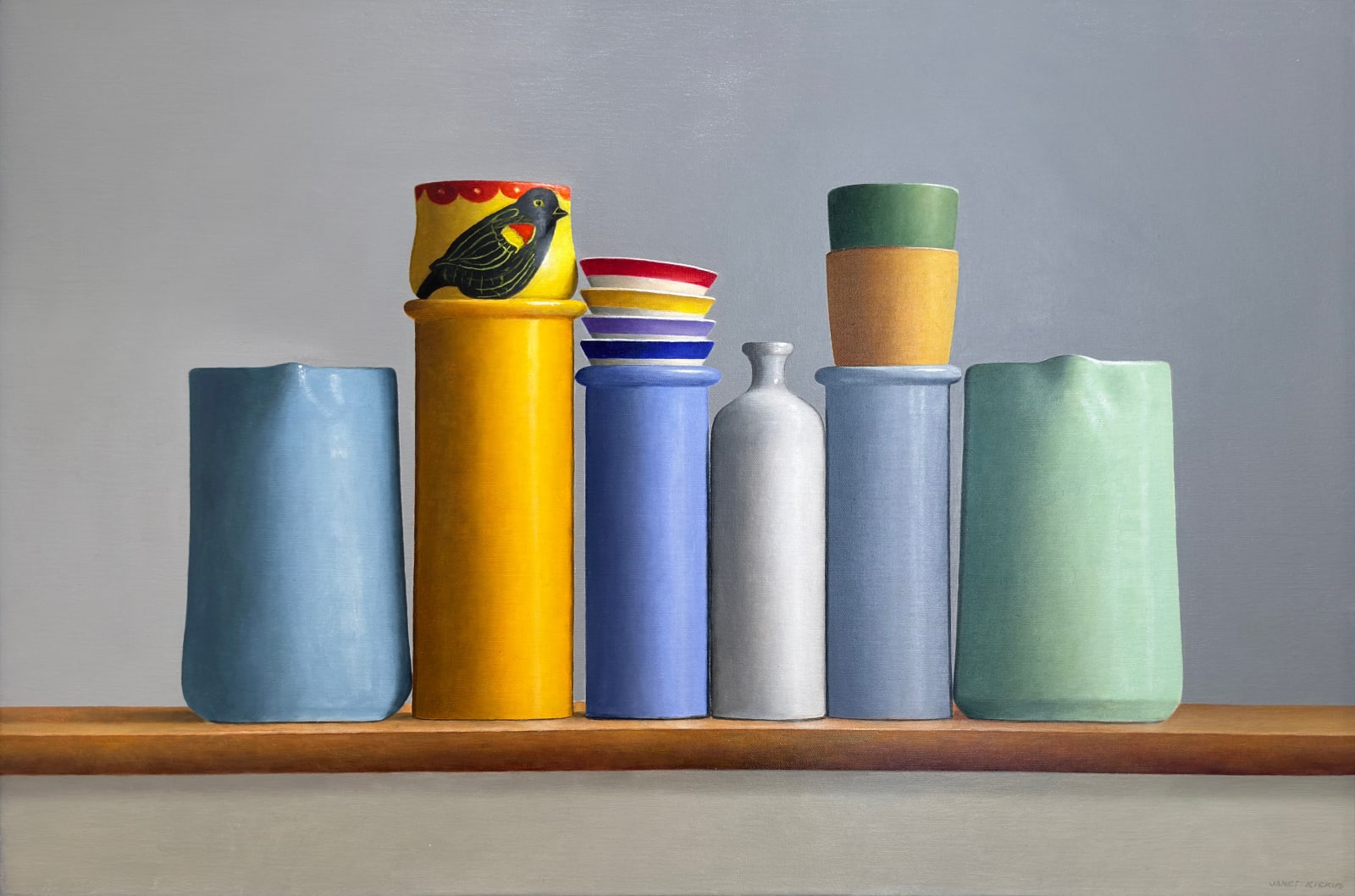 Blue and Yellow vessels on a table with a bird cup