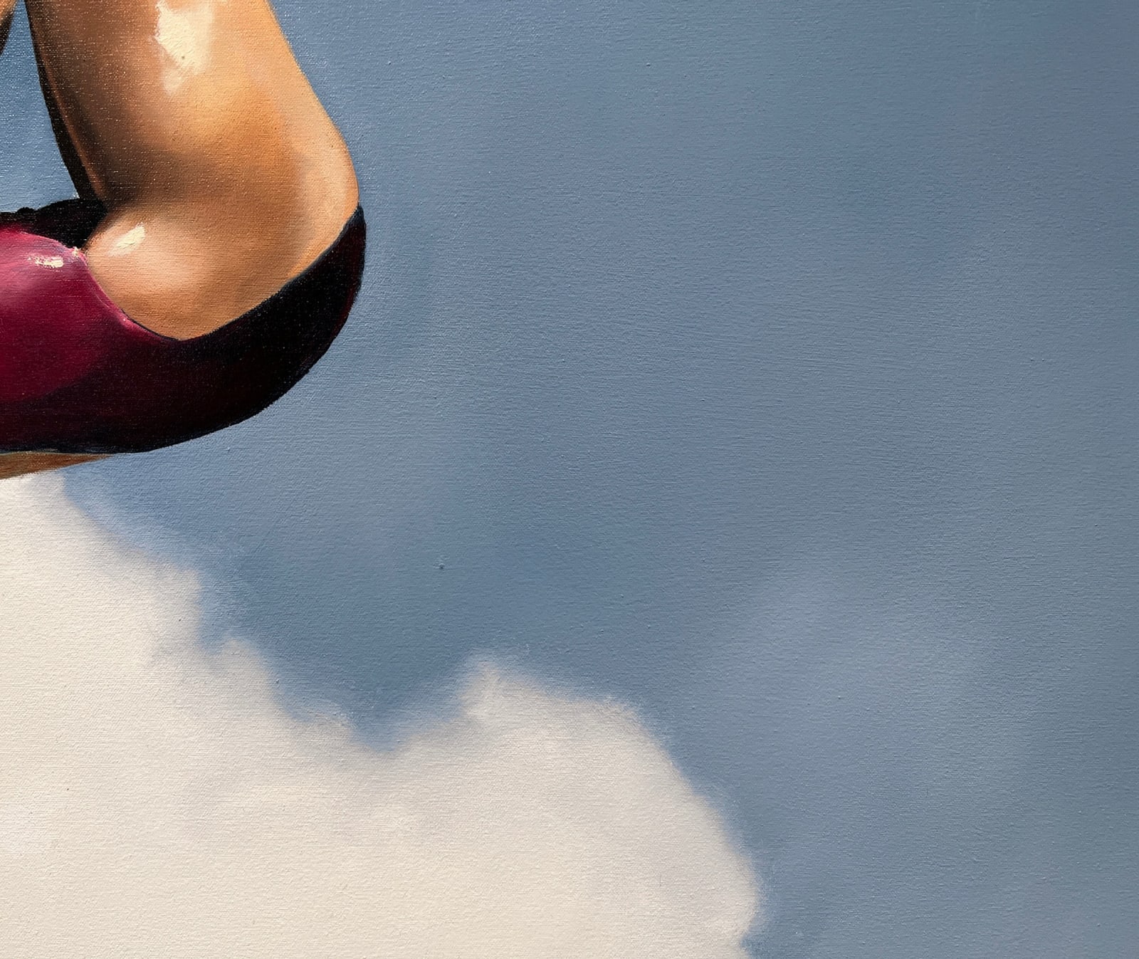 Woman in pink bathing suit soaring above the clouds
