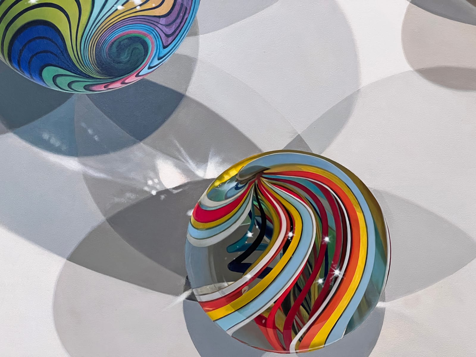 Photorealist painting of colorful marbles