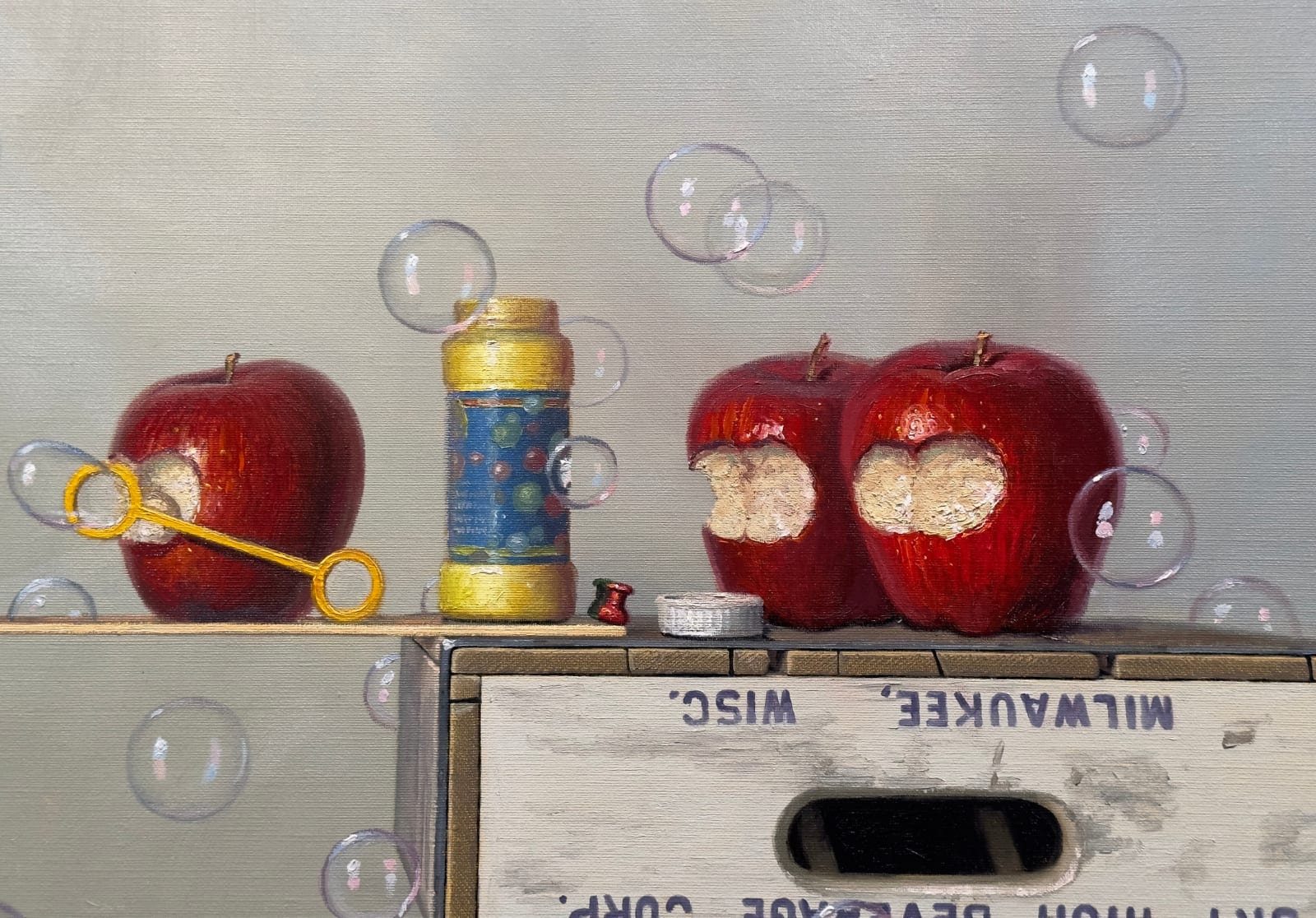 Soda crates stacked on top of each other with apples blowing bubbles atop