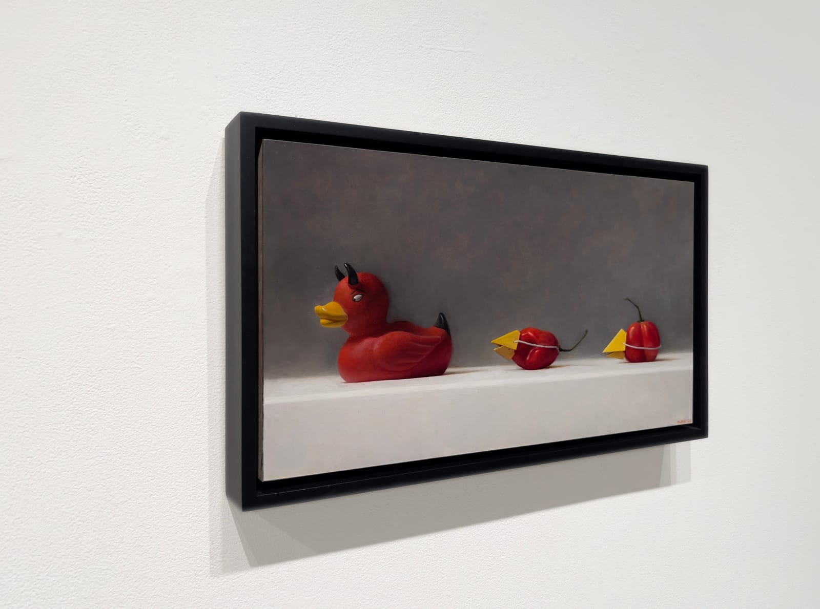 Painting of a red devil rubber duck and two habanero peppers with a paper yellow beak