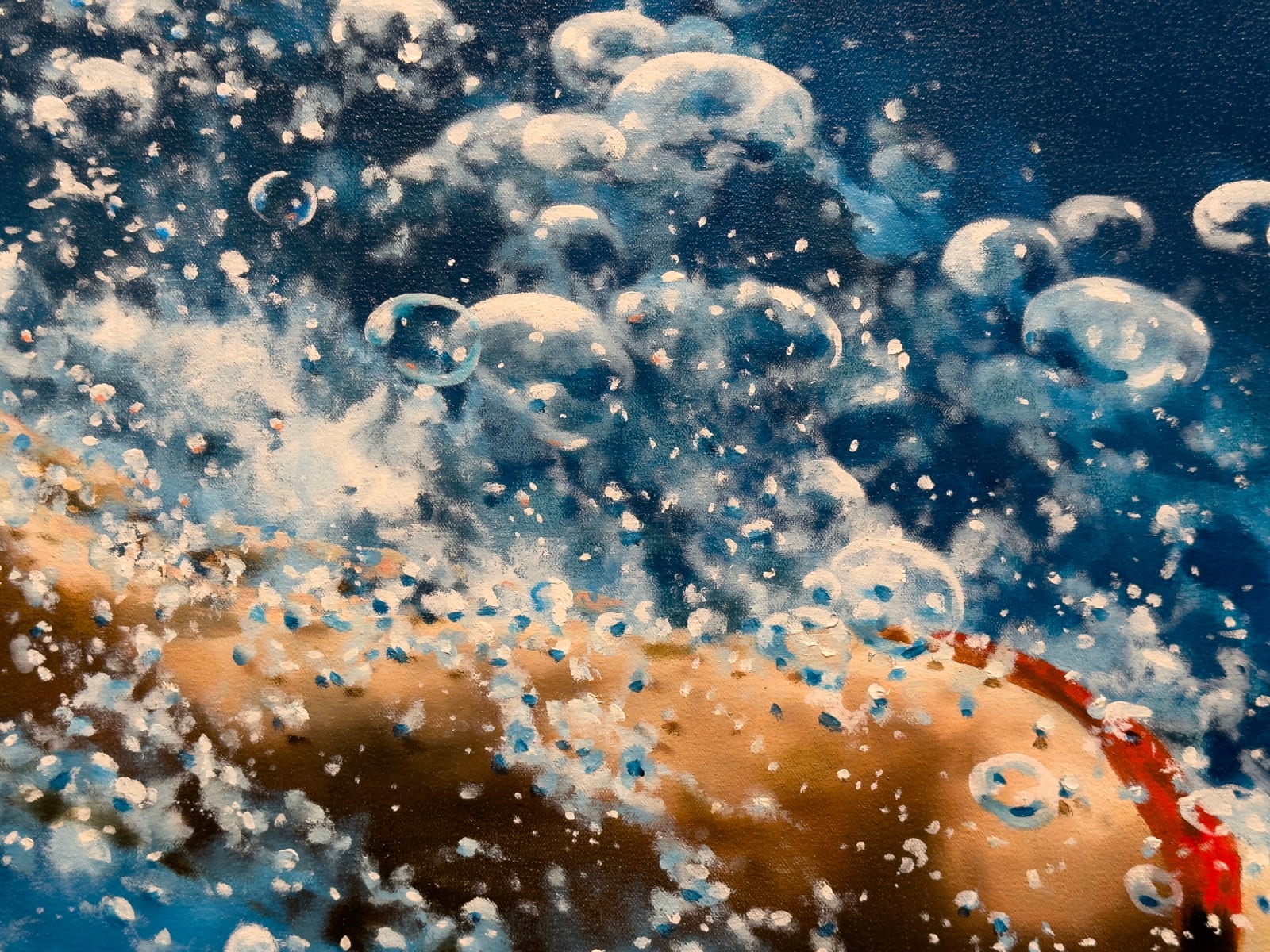 Woman in a red bikini diving through blue water