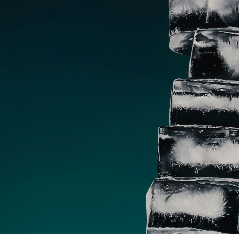 Detail of skinny stack of off center ice cubes before a green and black background