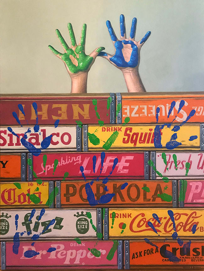Painted hands above boxes in blue and green with prints all over boxes