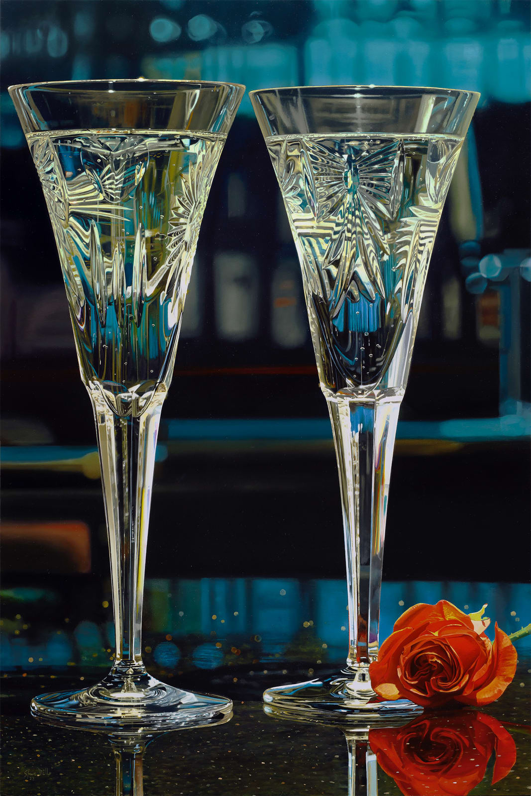 Two Crystal Champagne Glasses filled with bubbly and accompanied by a red rose.