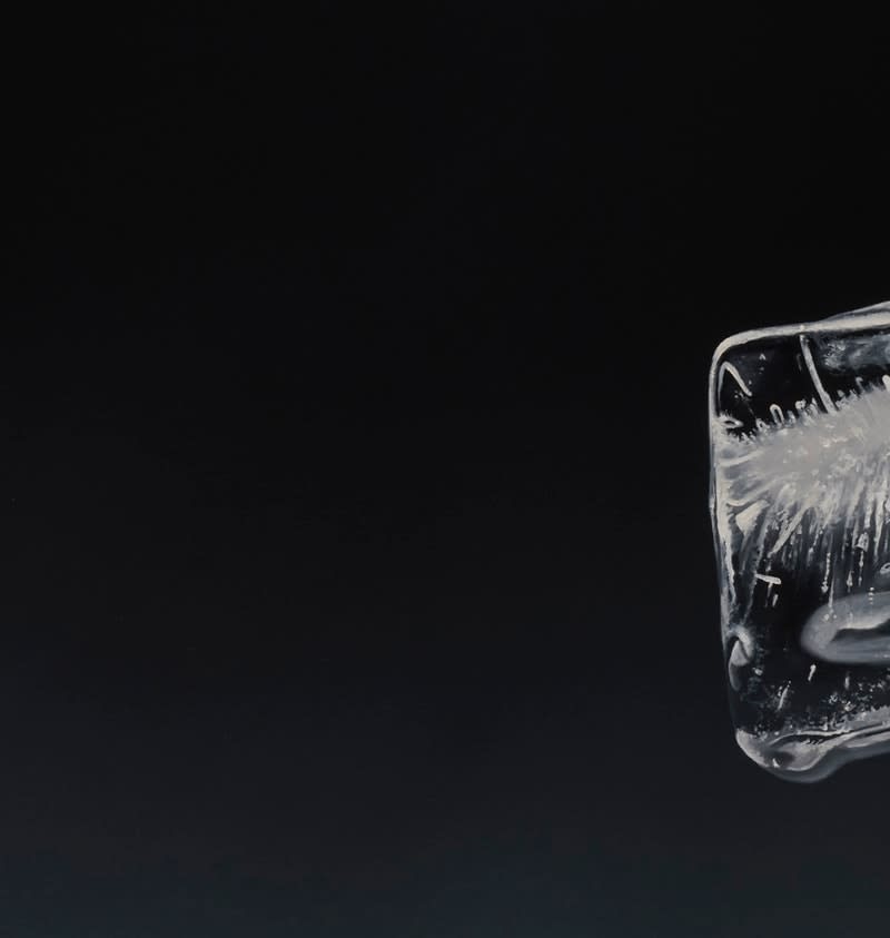 Detail of 3 Ice cubes stacked off center with grey and blue background