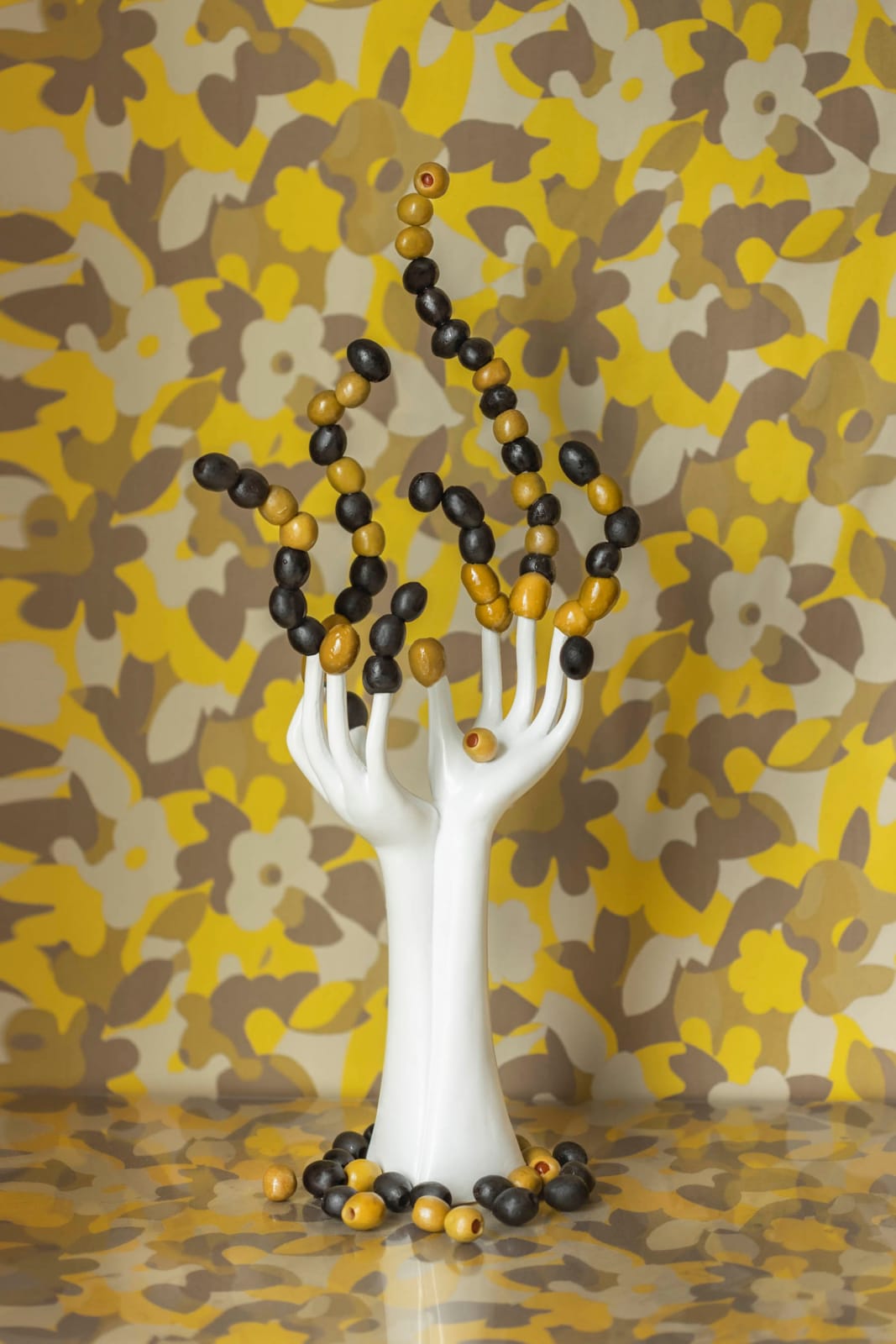 jp terlizzi photo of mannequin hands with olives on fingers