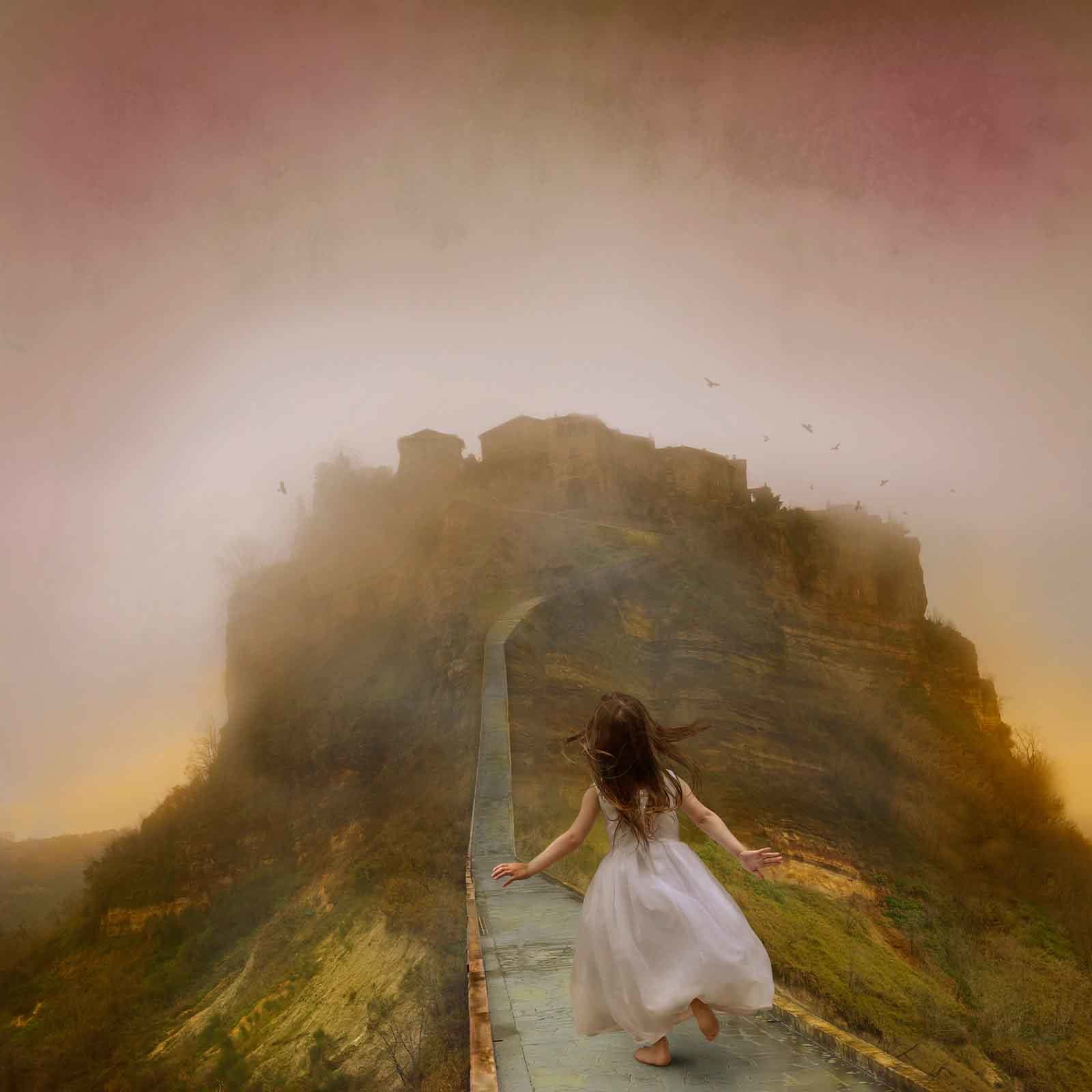 Tom Chambers photograph girl runs towards misty city on a hill purchase here Gilman Contemporary Sun Valley art gallery Idaho