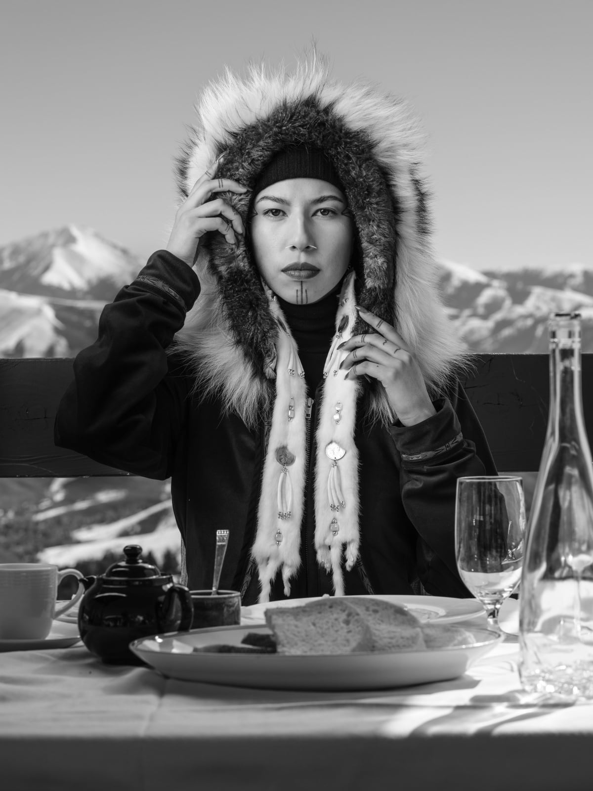 Sofia Jaramillo black and white archival pigment print Quannah Chasinghorse I of woman dining mountainside located at gilman contemporary sun valley