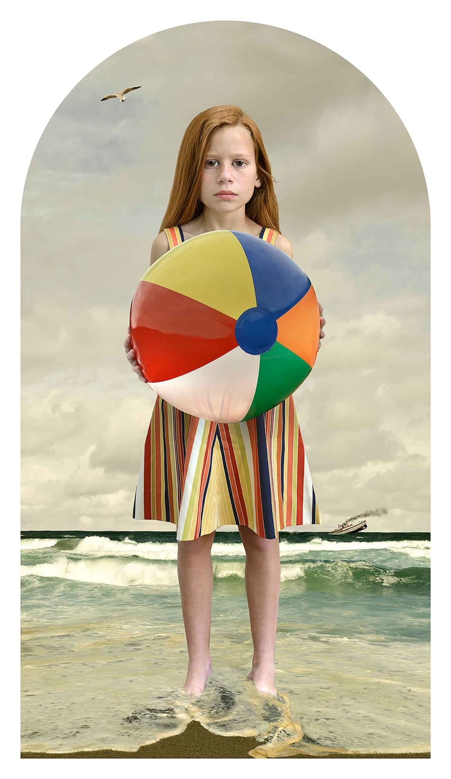 Tom Chambers in the summer girl with beach ball in the ocean waves
