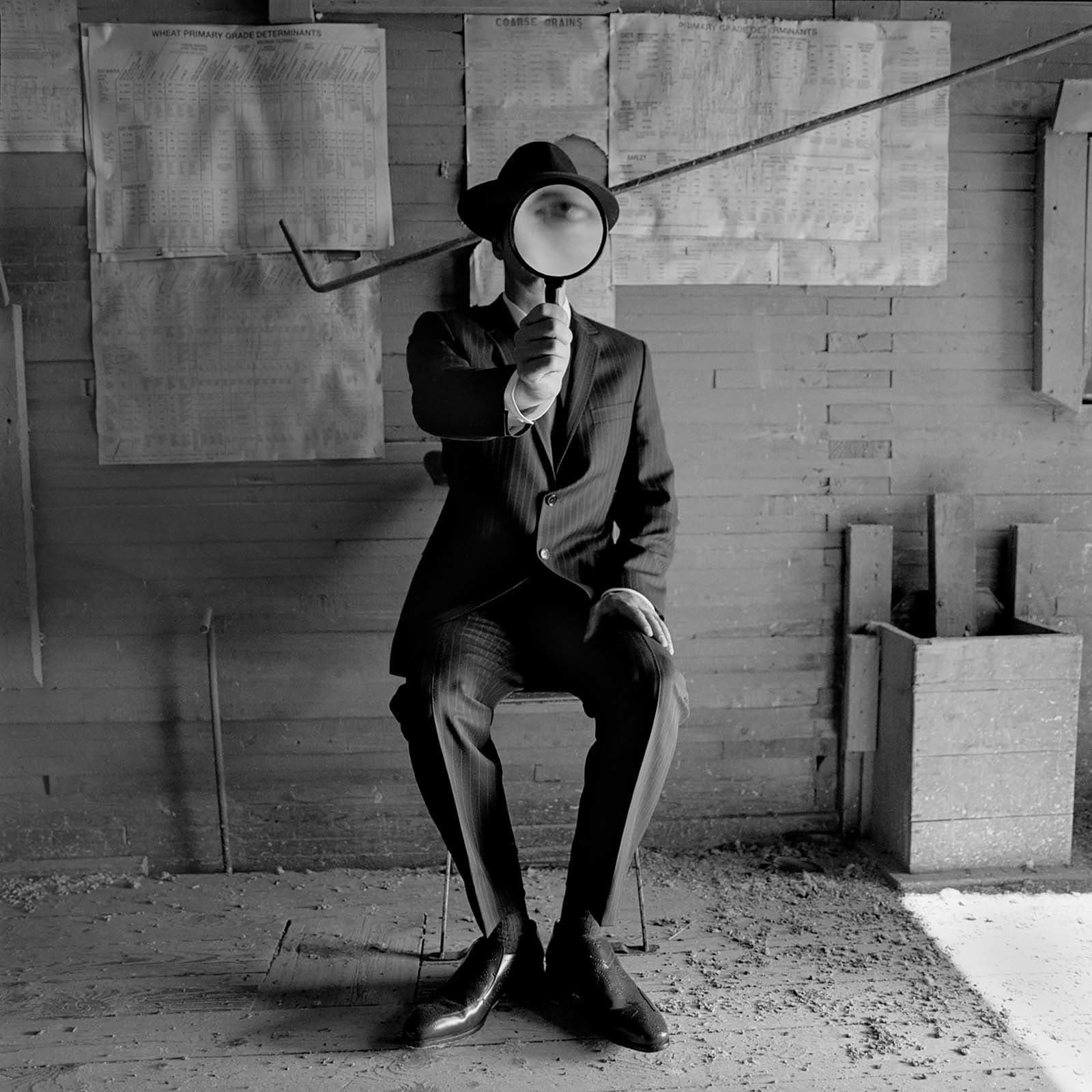 Rodney Smith phtograph buy here Gilman Contemporary Sun Valley art gallery man looking through a magnifying glass
