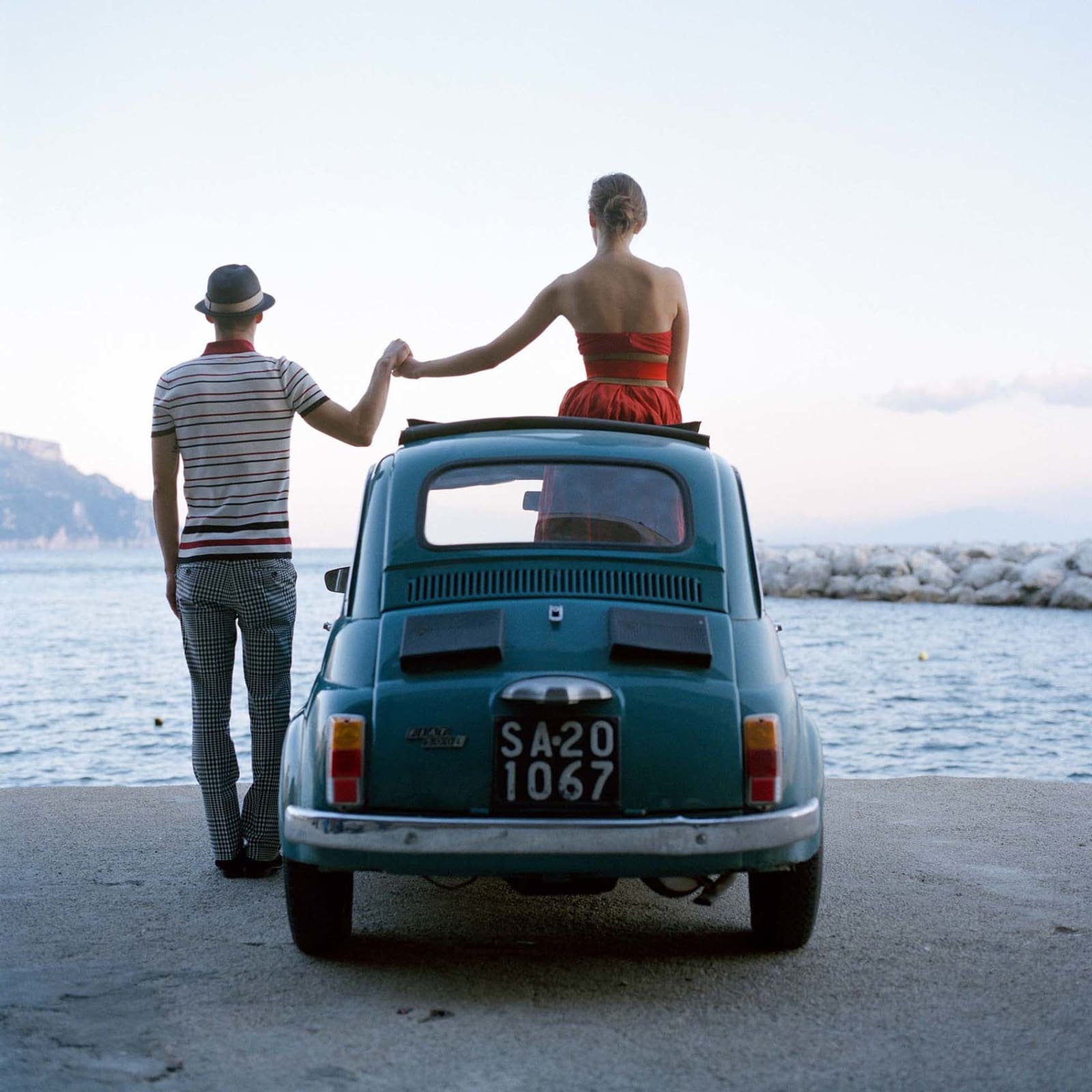 buy Rodney Smith photography woman sitting on a VW bug holding hands with a man Standing on the ground