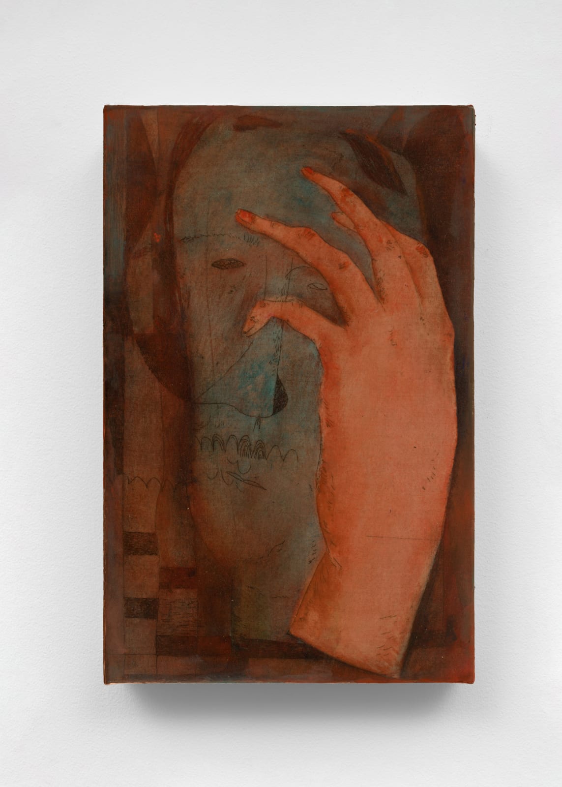 surrealistic image of a hand in the foreground and a blue face in the background