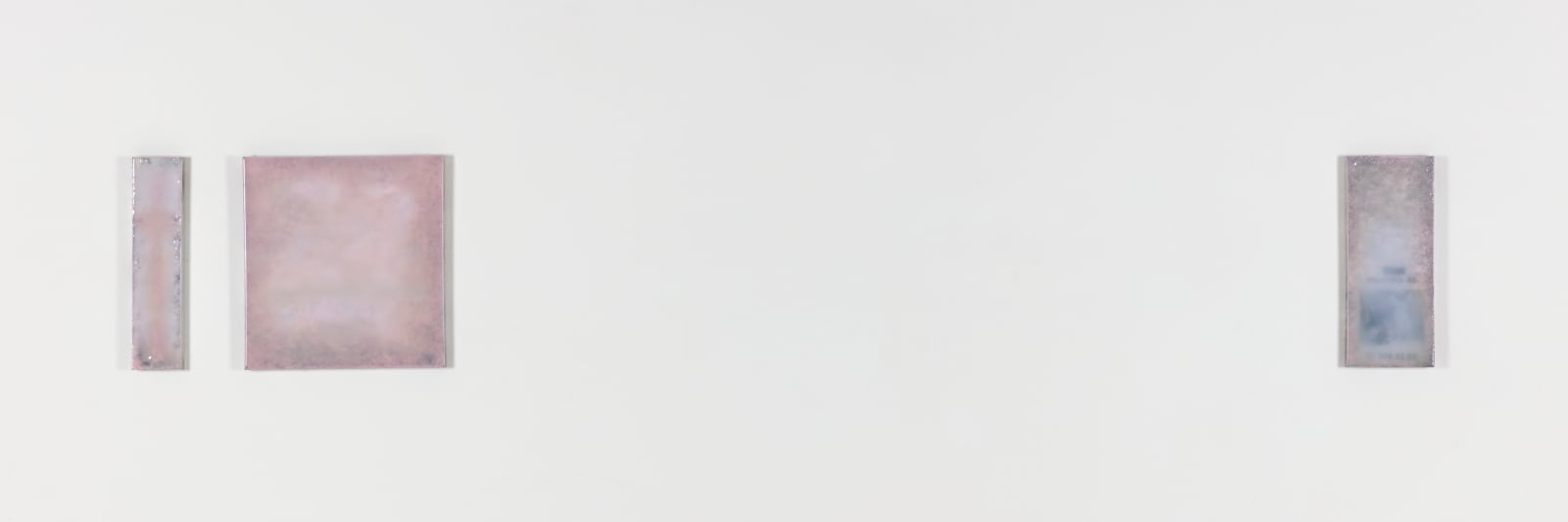 An image of three panels varying in width, pigment, and space against a white backdrop.