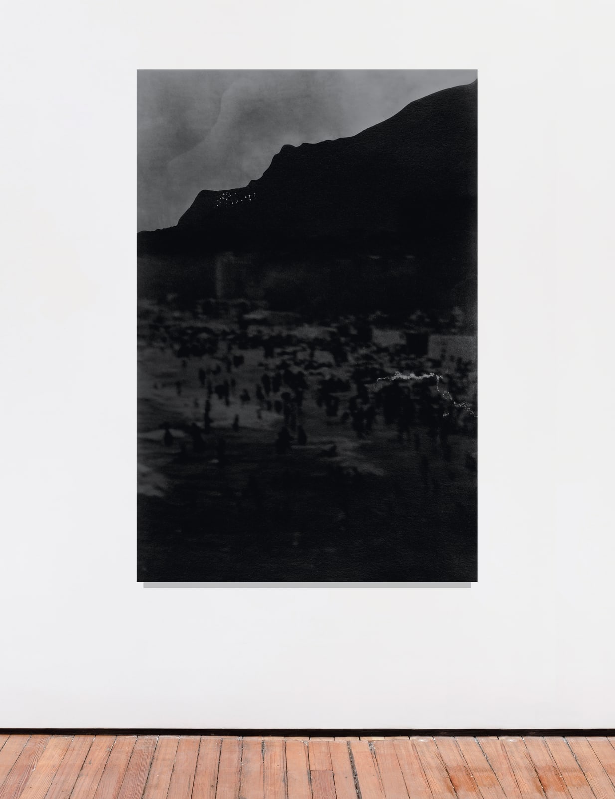 An inkjet print of a shadowy mountainous landscape.