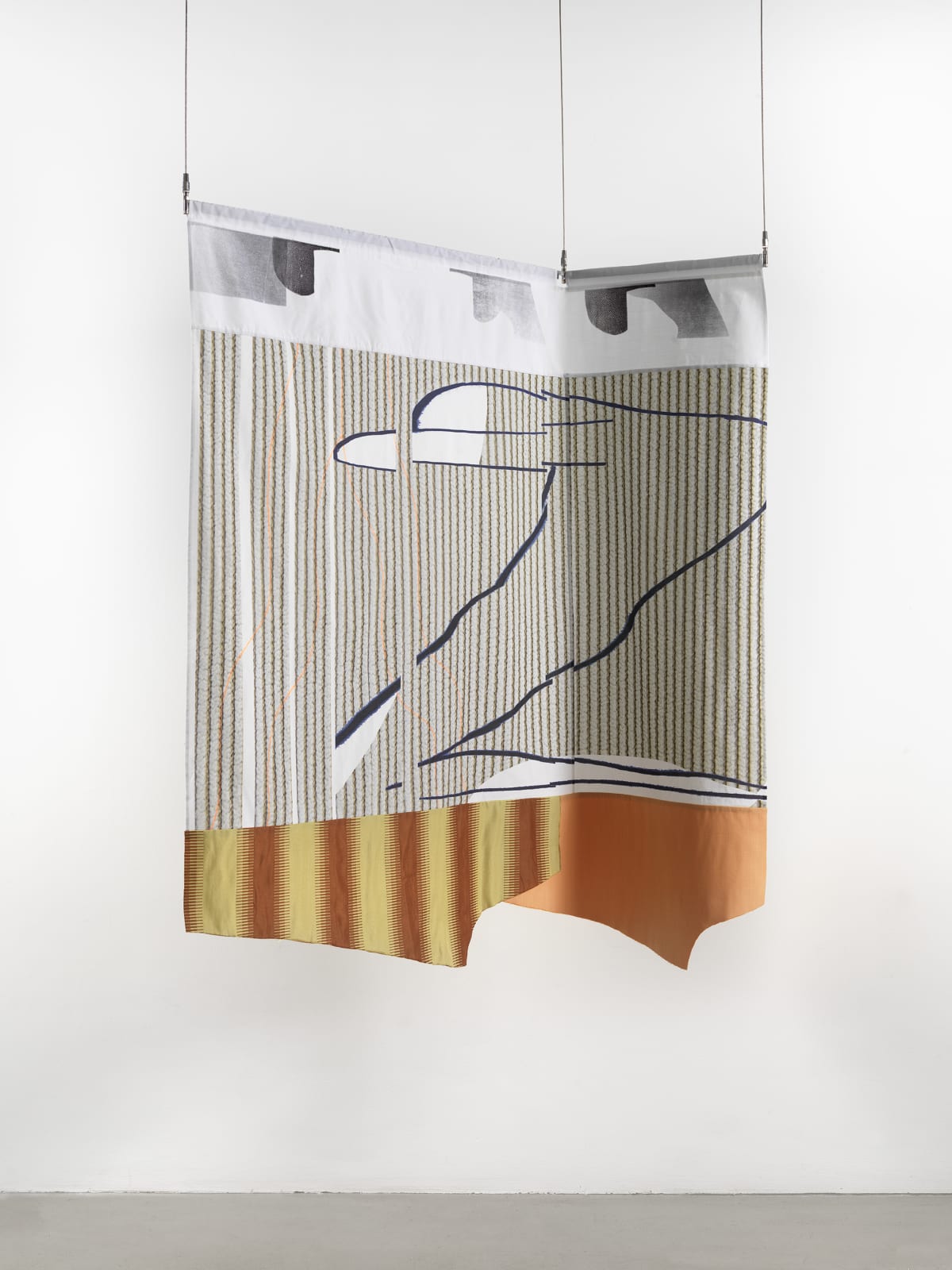 A gray-white, red, yellow and brown striped textile hanging against a white wall.