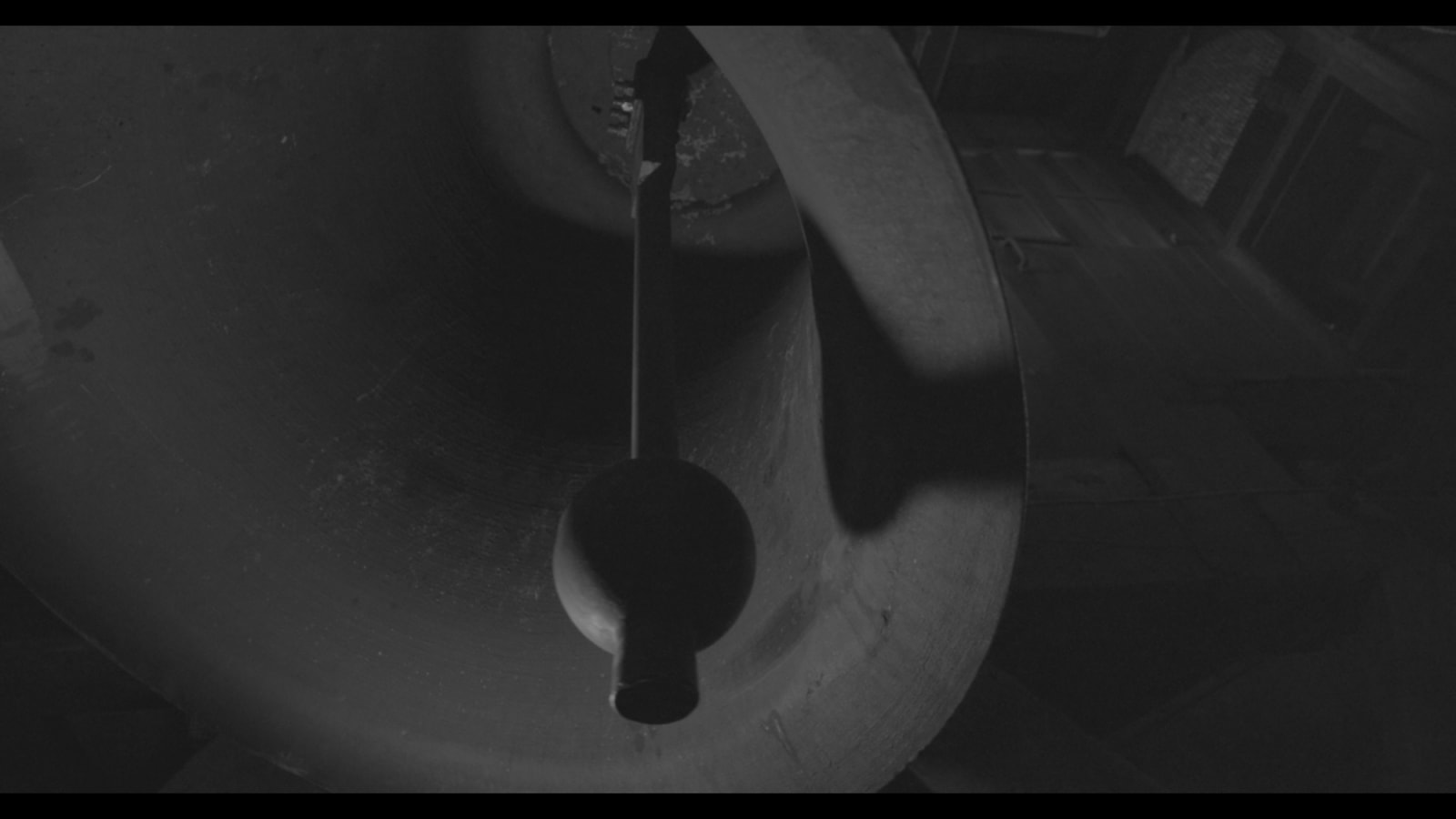 An inkjet print depicting a large, shadowy bell.