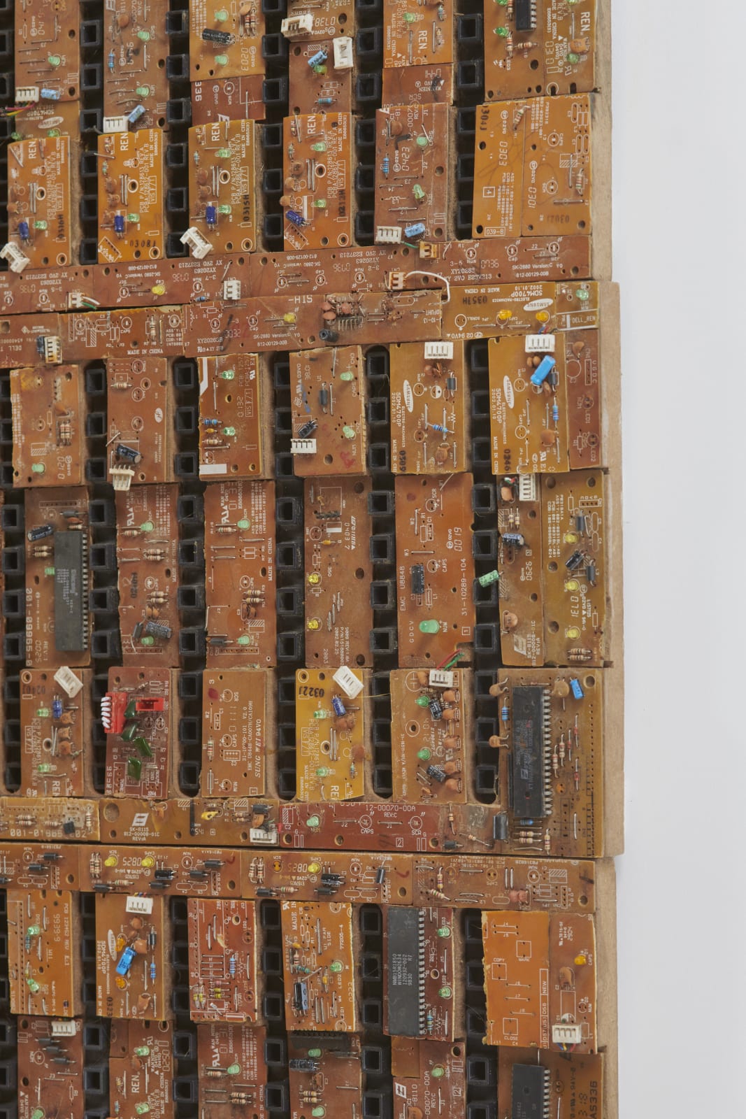 detail of a large mixed media work using reclaimed electrical wires and components on panel, characterized by a rows of black lines