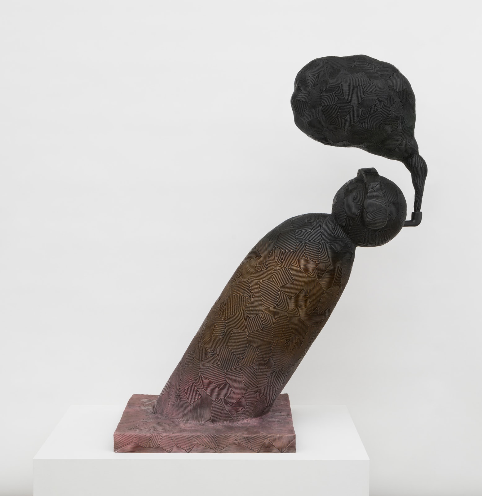 Free-standing bronze sculpture of a cartoonish character bent at a 45-degree angle with headphones on and smoking a pipe. A plume of smoke emanating from the pipe is cast with a surface texture resembling an abstract geometric pattern that matches the texture of the figure. The sculpture is treated with a purple patina that gradually turns to brown and to black, from bottom to top.  