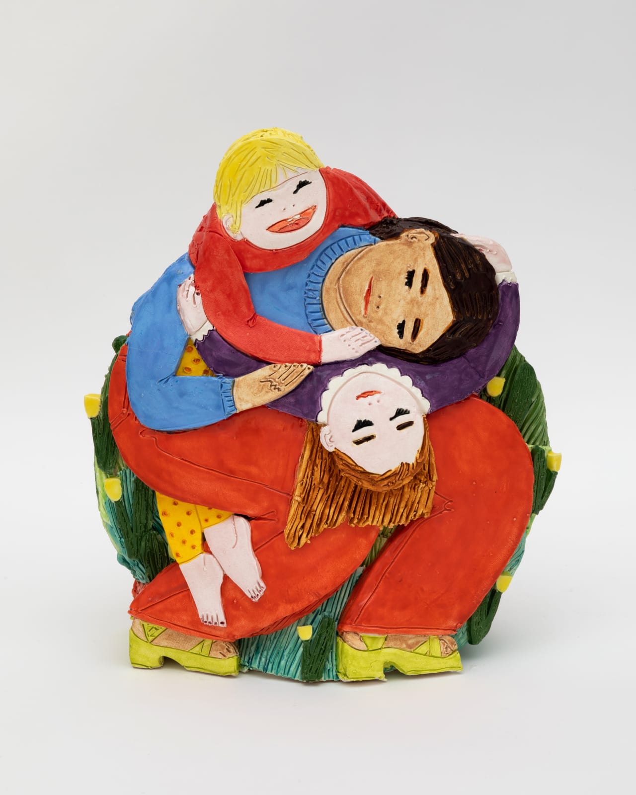 Ceramic sculpture of the artist holding her two children around her neck. 